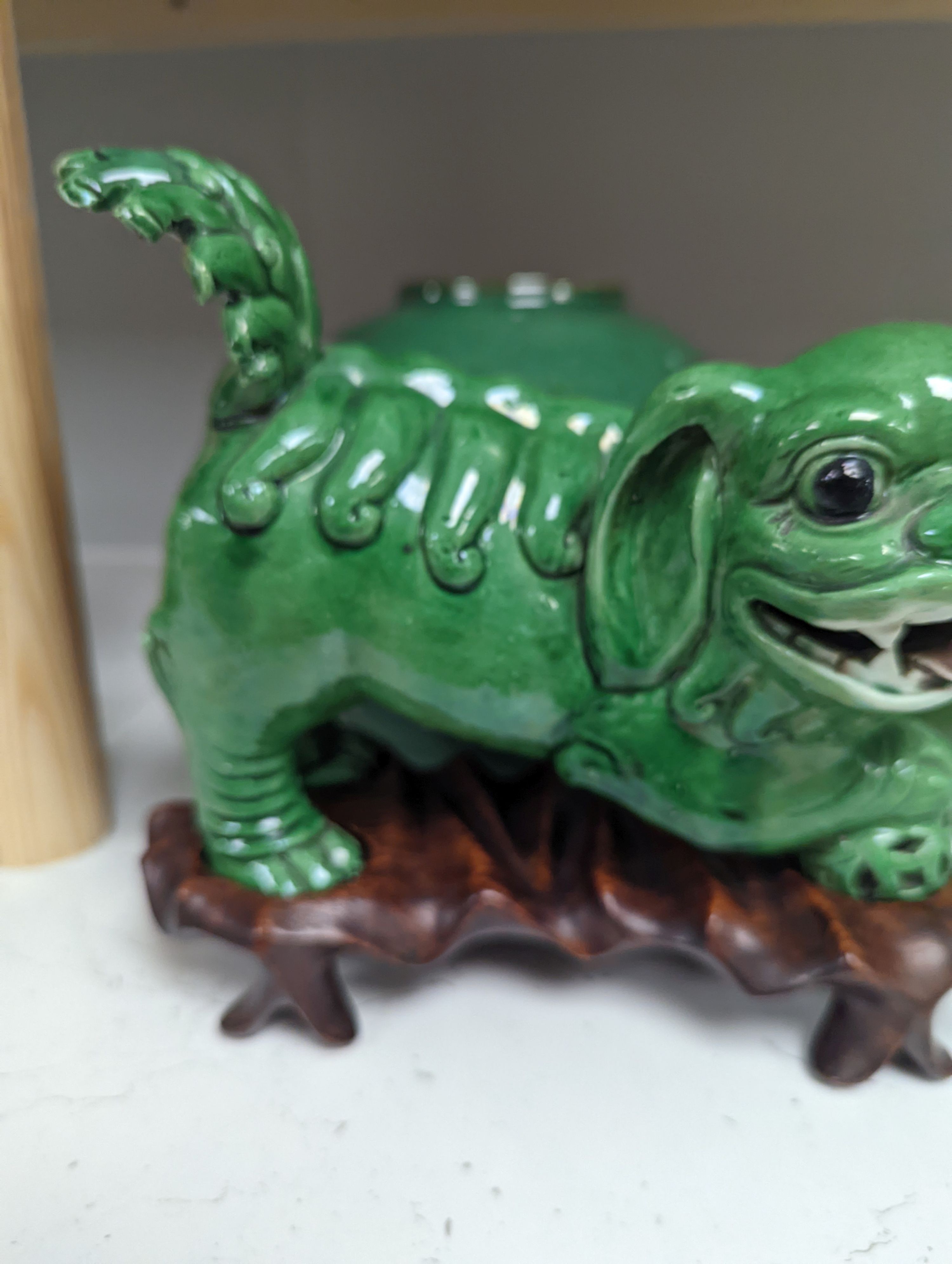 A 19th century Chinese green glazed model of a lion-dog, and two green crackle glaze jars, tallest 16cm